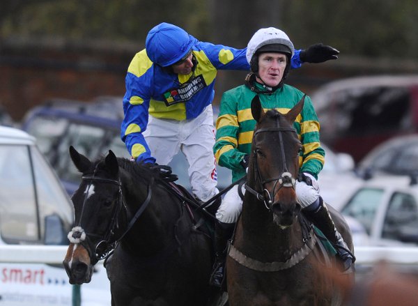 Tony McCoy riding Mountain Tunes (R) is congratulated by Harry Skelton after victory to give Tony McCoy his 4000th career win. Photo by Alan Crowhurst/Getty Images 