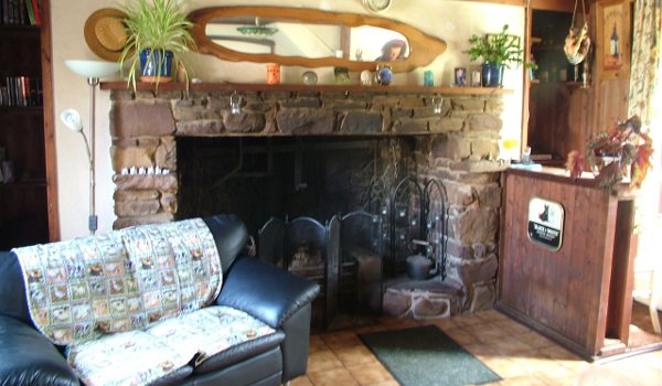 The sitting room features a grand traditional fireplace