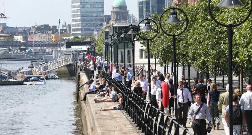 24/07/2014. Dublin Weather Scenes. Pictured are crowds enjoying the good weather today along the Liffey River by the IFSC in Dublin - today is forecast to be the hottest this week with temperatures of up to 27 degrees Celsius. Photo: Sasko Lazarov/RollingNews.ie
