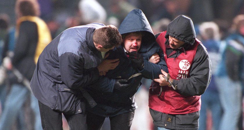 An Irish fan is helped by stewards after a missile is launched as England fans riot at Lansdowne Road in 1995 (Photo: Clive Brunskill/ALLSPORT)