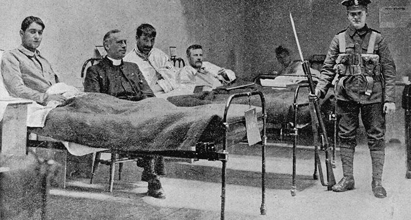 A British army soldier stands guard over Irish republican prisoners in a temporary hospital at Dublin Castle following the Easter Rising, Ireland, 1916. Original publication: The Graphic, pub. 13th May 1916. (Photo by Hulton Archive/Getty Images)