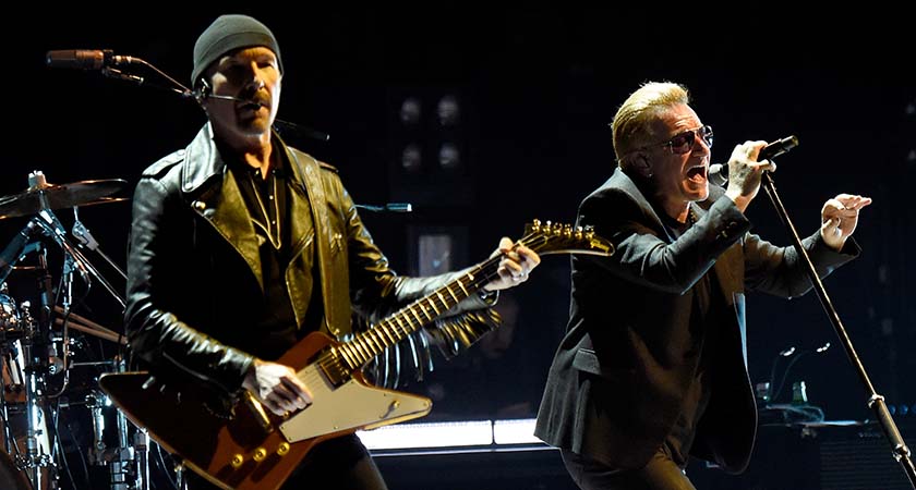 The Edge (L) and Bono of U2 perform onstage during the U2 iNNOCENCE + eXPERIENCE tour opener (Photo by Kevin Mazur/WireImage)