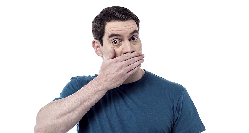 Shocked man covering mouth with hand