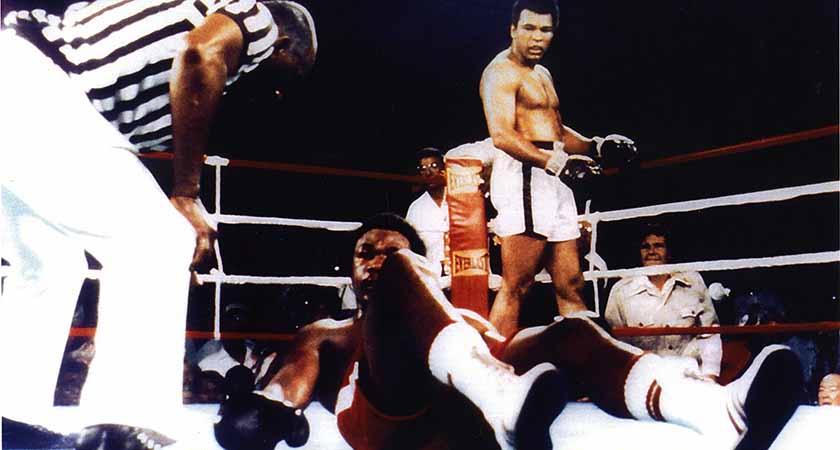 Gene (right) looks on from behind the ropes as Ali floors Foreman