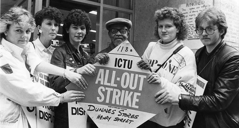 Dunnes Stores workers on strike outside Dunnes on Henry Street. L to R. Sandra Griffen, Alma Bonnie, Karen Gearon, "Nimrod", Mary Manning with anti apartheid activist Nimrod Sejake and Tommy Davis. 25/5/1985 Photo: RollingNews.ie