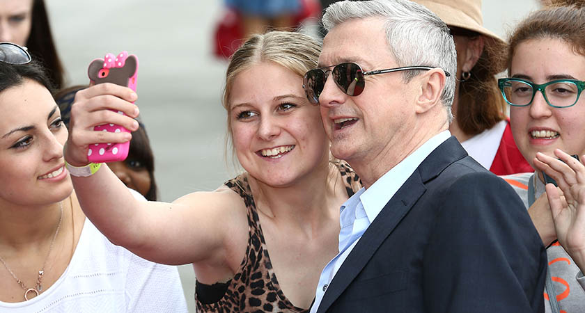 Louis Walsh poses with a fan as he arrives for the London Auditions of X Factor in London last year  (Photo by Tim P. Whitby/Getty Images)