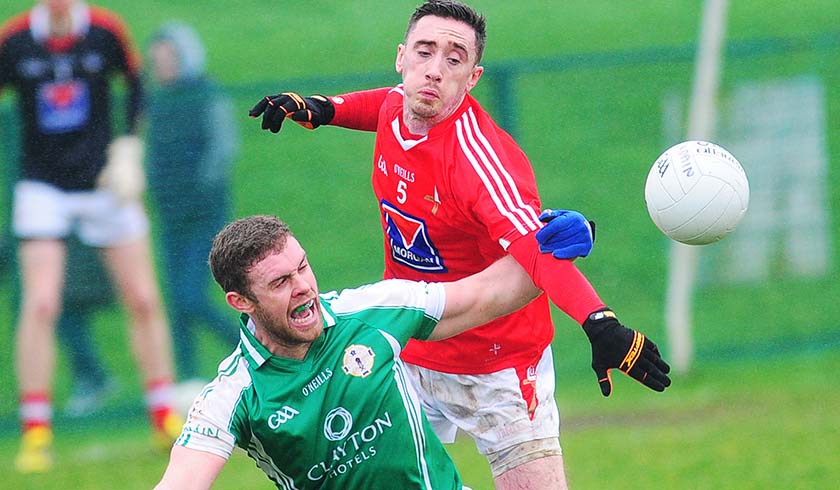 Derek Maguire gets this ball away from  Scott Conroy in Sunday,s game in Darver