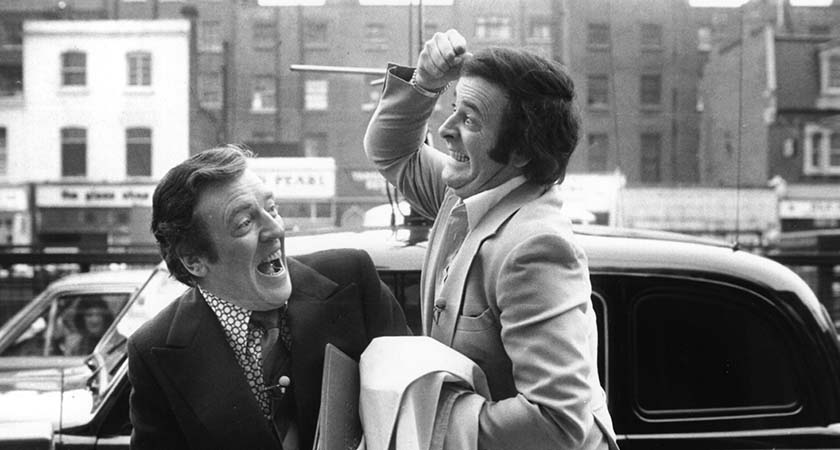 Terry Wogan, broadcaster and writer, cavorts with fellow broadcaster Eamonn Andrews (1922 - 1987).   (Photo by Evening Standard/Getty Images)