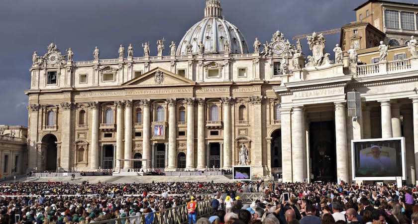 Rome, Italy - October 22, 2014: Papal Audience in St. Peter's Square, Vatican City with the Pope Francis praying under the canopy and an crowd in square San Pietro on October 22, 2014.