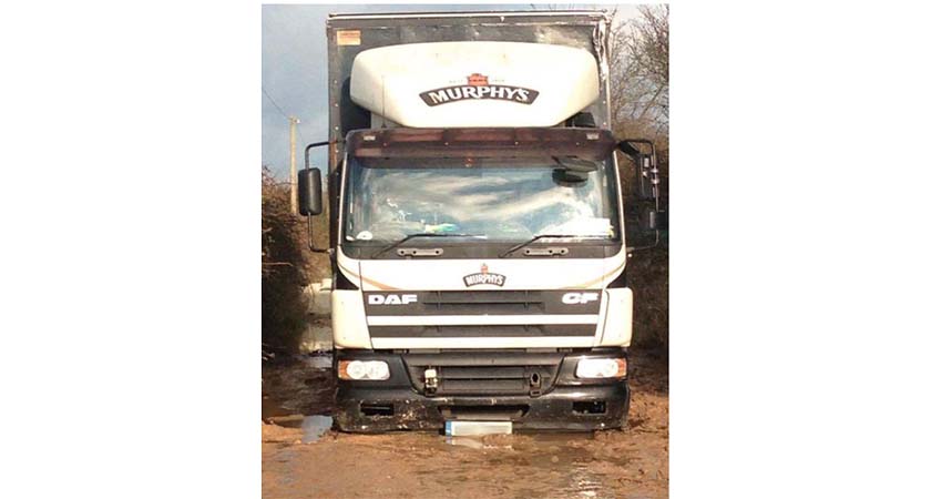 According to The Irish Queenslander, this lorry was on its way to deliver Murphy's to a pub in Midleton when its three axles were swallowed by a massive pothole. (Source: The Irish Queenslander/Kevin Heffernan) 