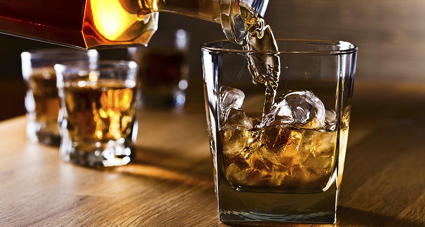 whiskey and natural ice on old wooden table