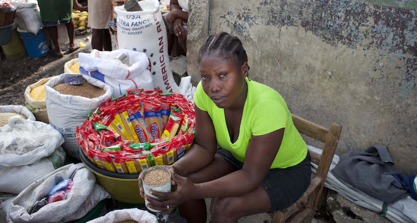 Wilmise Saintilma, has her own business selling food in a market in Carrefour. Port au Prince, Haiti. Sterlyn - 14 D'jouna - 11 Fritna - 8