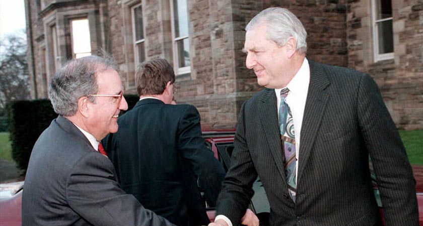 Patrick Mayhew (right) greets Senator George Mitchell in Belfast (Picture: Alan Lewis/AFP/Getty Images)