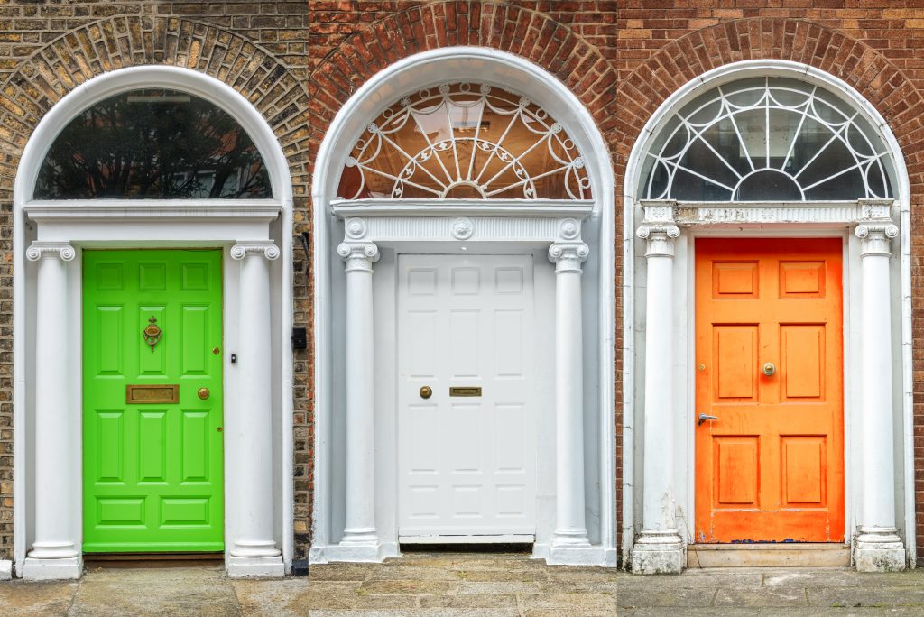 A set of doors lined up to match the colours of the Irish flag.