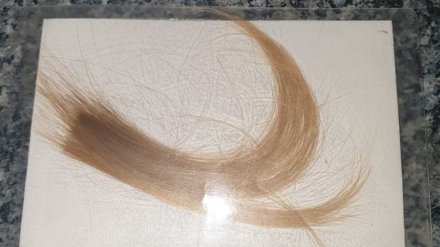 Mother of two-year-old who died in 2013 makes emotional appeal for stolen lock of hair.